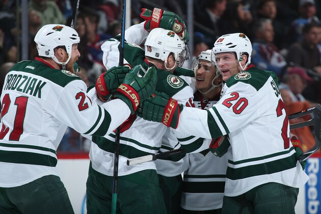 DENVER, CO - APRIL 30:  Jared Spurgeon (2R) #46 of the Minnesota Wild celebrates his goal against the Colorado Avalanche with teammates Kyle Brodziak #21, Dany Heatley #15 and Ryan Suter #20 of the Minnesota Wild to tie the score 4-4 in the third period and send the game to overtime in Game Seven of the First Round of the 2014 NHL Stanley Cup Playoffs at Pepsi Center on April 30, 2014 in Denver, Colorado.  (Photo by Doug Pensinger/Getty Images)
