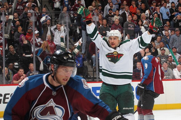 DENVER, CO - APRIL 30:  Nino Niederreiter #22 of the Minnesota Wild celebrates his overtime, series-winning goal as Erik Johnson #6 of the Colorado Avalanche reacts in Game Seven of the First Round of the 2014 Stanley Cup Playoffs at the Pepsi Center on April 30, 2014 in Denver, Colorado.  The Wild defeated the Avalanche in overtime 5-4.  (Photo by Michael Martin/NHLI via Getty Images)