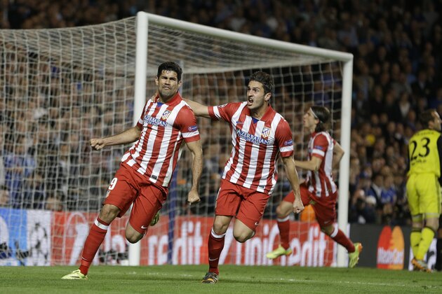 Atletico's Diego Costa, left celebrates with  Koke after he scored a penalty during the Champions League semifinal second leg soccer match between Chelsea and Atletico Madrid at Stamford Bridge Stadium in London Wednesday, April 30, 2014. (AP Photo/Kirsty Wigglesworth)