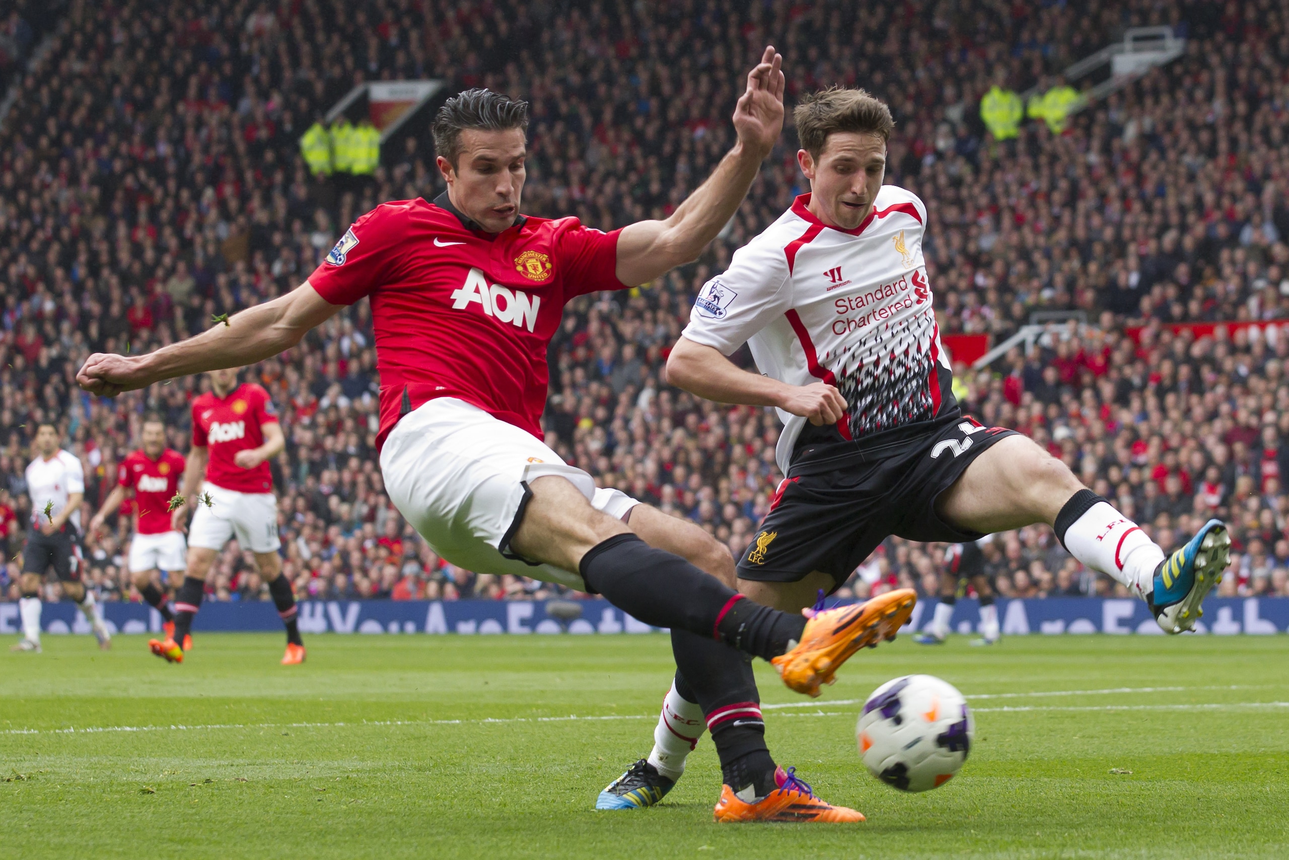 Manchester United's Robin van Persie, fights for the ball against Liverpool's Joe Allen during their English Premier League soccer match at Old Trafford Stadium, Manchester, England, Sunday March 16, 2014. (AP Photo/Jon Super)