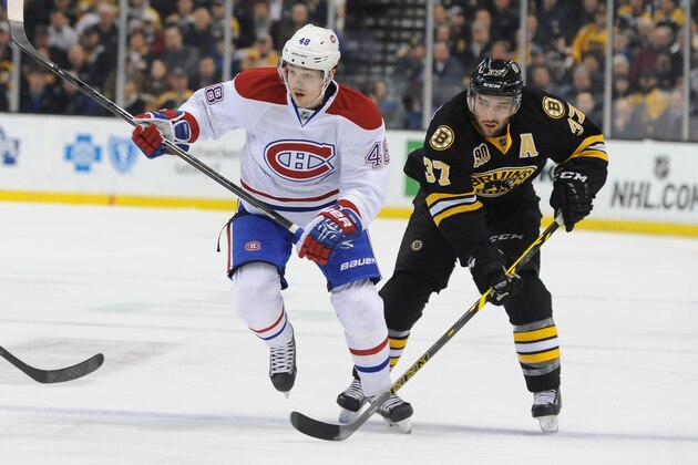 BOSTON, MA - MARCH 24: Patrice Bergeron #37 of the Boston Bruins skates against Daniel Briere #48 of the Montreal Canadiens at the TD Garden on March 24, 2014 in Boston, Massachusetts.  (Photo by Steve Babineau/NHLI via Getty Images)
