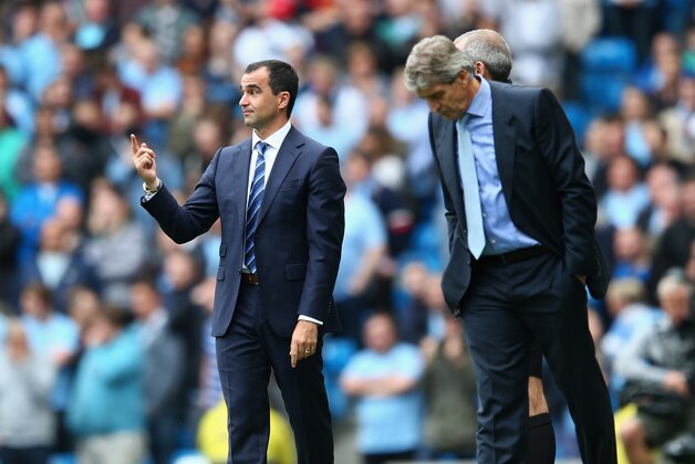 MANCHESTER, ENGLAND - OCTOBER 05:  Manuel Pellegrini (R) the manager of Manchester City alongside Roberto Martinez (L) the manager of Evertonon during the Barclays Premier League match between Manchester City and Everton at the Etihad Stadium on October 5, 2013 in Manchester, England.  (Photo by Michael Steele/Getty Images)