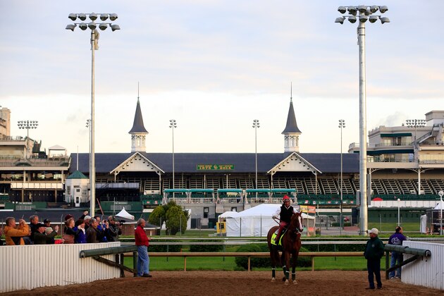 LOUISVILLE, KY - MAY 01:  California Chrome walks off the track with trainer Art Sherman in front of the twin spires during early morning workouts at Churchill Downs on May 1, 2014 in Louisville, Kentucky.  (Photo by Jamie Squire/Getty Images)