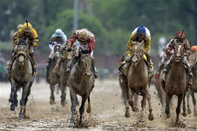 Jockey Joel Rosario, third from left, celebrates as Orb crosses the finish line to win the 139th Kentucky Derby horse race at Churchill Downs Saturday, May 4, 2013, in Louisville, Ky.  (AP Photo/Darron Cummings)