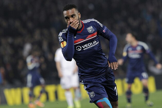Lyon's Alexandre Lacazette celebrates after scoring a goal against Viktoria Plzen during their Europa League soccer match in Lyon, central France, Thursday, March 13, 2014. (AP Photo/Laurent Cipriani)