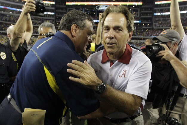 Alabama head coach Nick Saban, right, and Michigan head coach Brady Hoke hug after their NCAA college football game at Cowboys Stadium in Arlington, Texas, Saturday, Sept. 1, 2012. Alabama  won 41-14.  (AP Photo/LM Otero)
