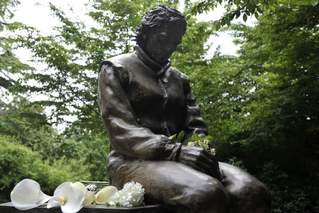 Flowers lie next to a statue of Ayrton Senna, in a park close to the Imola track, Italy, Wednesday, April 30, 2014. It is a testament to Ayrton Senna's lasting impact on Formula One that the 20th anniversary of his death will be observed this week with five days of commemorations at the Imola track where he had his fatal accident. Current and past F1 drivers, mechanics, racing officials and fans will pay their respects to Senna and Austrian driver Roland Ratzenberger, who also died at the 1994 San Marino Grand Prix. (AP Photo/Marco Vasini)