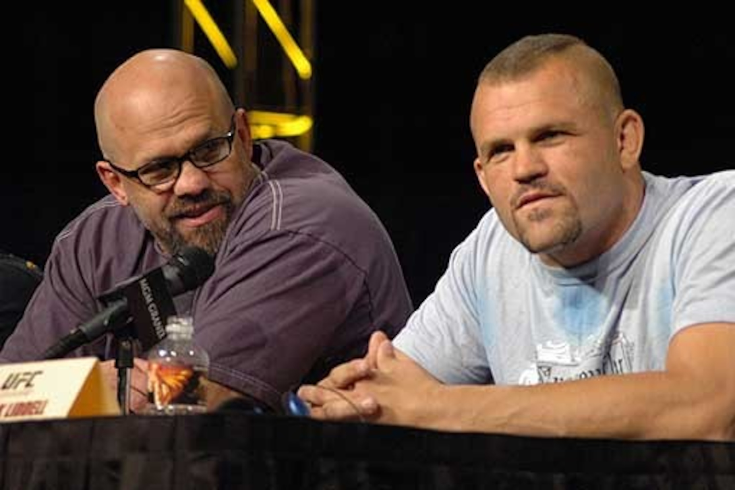 John Hackleman (left) sits with Chuck Liddell at a press conference.