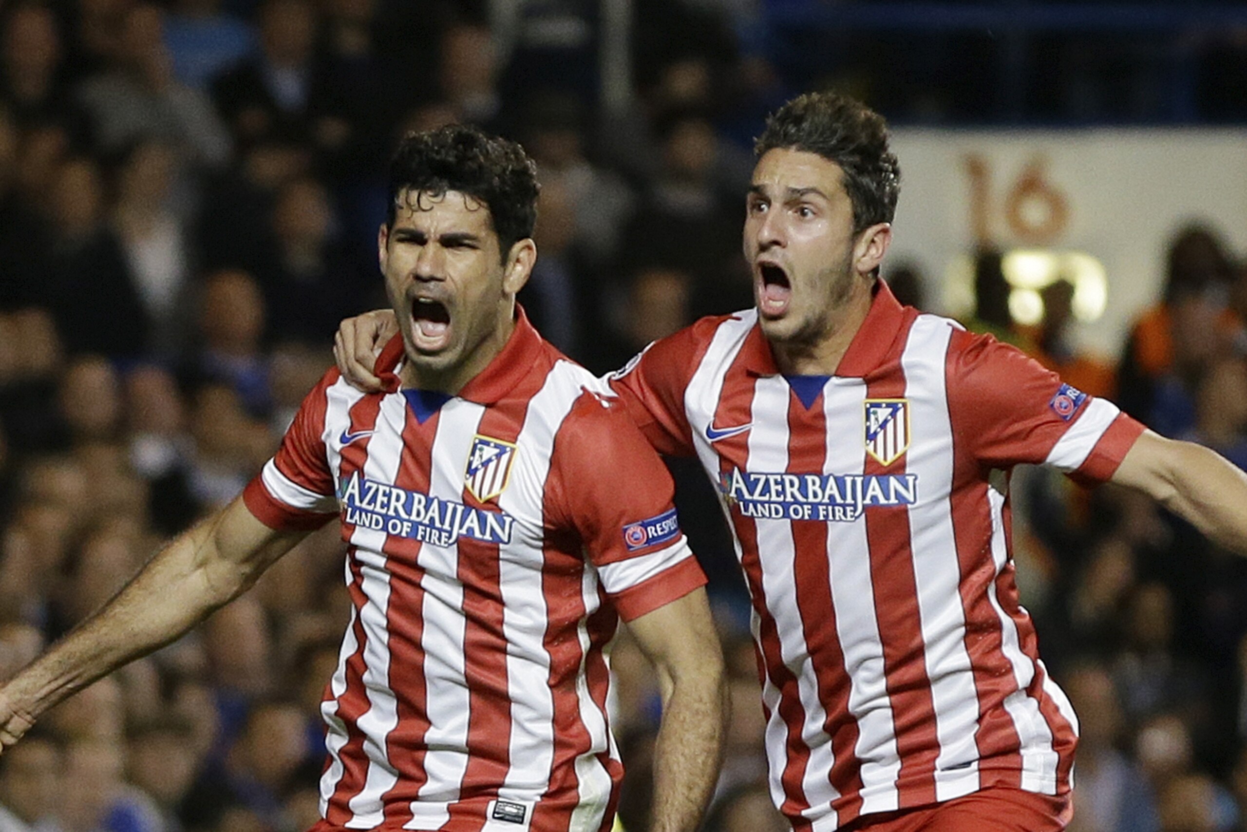 Atletico's Diego Costa, left celebrates with  Koke after he scored a penalty during the Champions League semifinal second leg soccer match between Chelsea and Atletico Madrid at Stamford Bridge Stadium in London Wednesday, April 30, 2014. (AP Photo/Kirsty Wigglesworth)