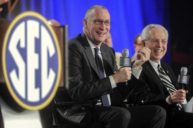 FILE - In this May 2, 2013 file photo, ESPN President John Skipper, left, and Southeastern Conference Commissioner Mike Slive address the media during a news conference announcing the launching of the SEC Network in partnership with ESPN, in Atlanta. ESPN is cutting its workforce, the latest Disney division to reduce staff. While announcing cuts Tuesday, ESPN will still be expanding in other areas.  (AP Photo/John Amis, File)