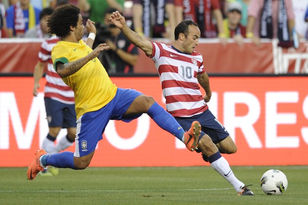 United States' Landon Donovan (10) prepares to kick the ball against Brazil's Marcelo (6) during the first half of an international friendly soccer game, Wednesday, May 30, 2012, in Landover, Md. (AP Photo/Nick Wass)
