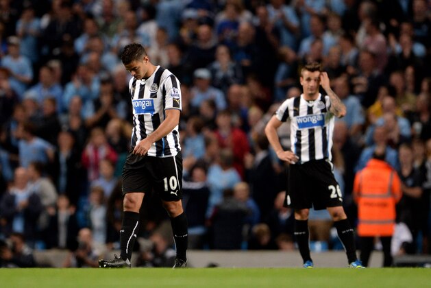 MANCHESTER, ENGLAND - AUGUST 19:  (L-R) Dejected newcastle teammates Hatem Ben Arfa and Mathieu Debuchy look on after conceding four goals during the Barclays Premier League match between Manchester City and Newcastle United at the Etihad Stadium on August 19, 2013 in Manchester, England.  (Photo by Michael Regan/Getty Images)