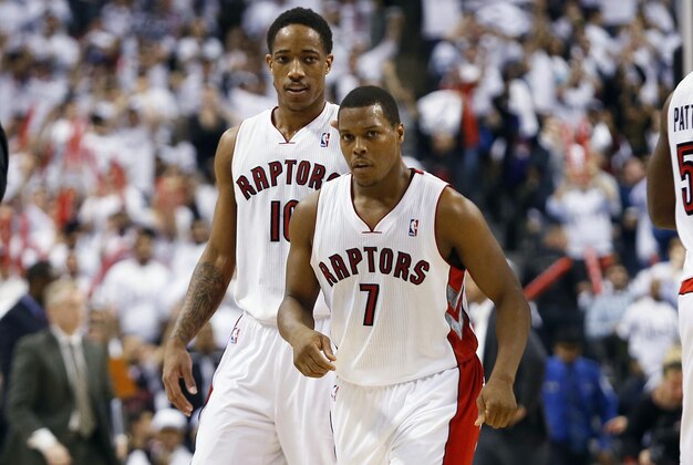 Apr 30, 2014; Toronto, Ontario, CAN; Toronto Raptors guard DeMar DeRozan (10) and guard Kyle Lowry (7) come off the court during a break in the action against the Brooklyn Nets in game five of the first round of the 2014 NBA Playoffs at the Air Canada Centre. Toronto defeated Brooklyn 115-113. Mandatory Credit: John E. Sokolowski-USA TODAY Sports