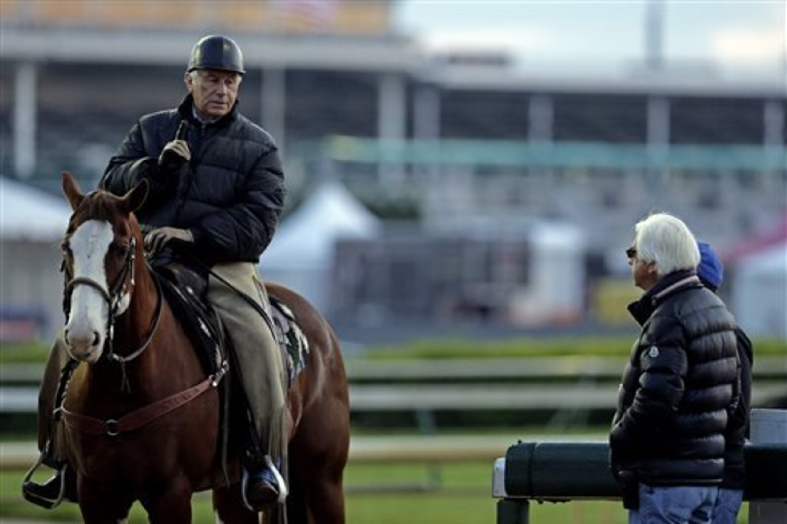 Trainers D. Wayne Lukas, left, and Bob Baffert talk during morning workouts at Churchill Downs Thursday, May 1, 2014, in Louisville, Ky. (AP Photo/Charlie Riedel)