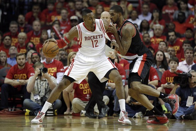 Apr 30, 2014; Houston, TX, USA; Houston Rockets center Dwight Howard (12) is defended by Portland Trail Blazers forward LaMarcus Aldridge (12) during the third quarter in game five of the first round of the 2014 NBA Playoffs at Toyota Center. Mandatory Credit: Andrew Richardson-USA TODAY Sports