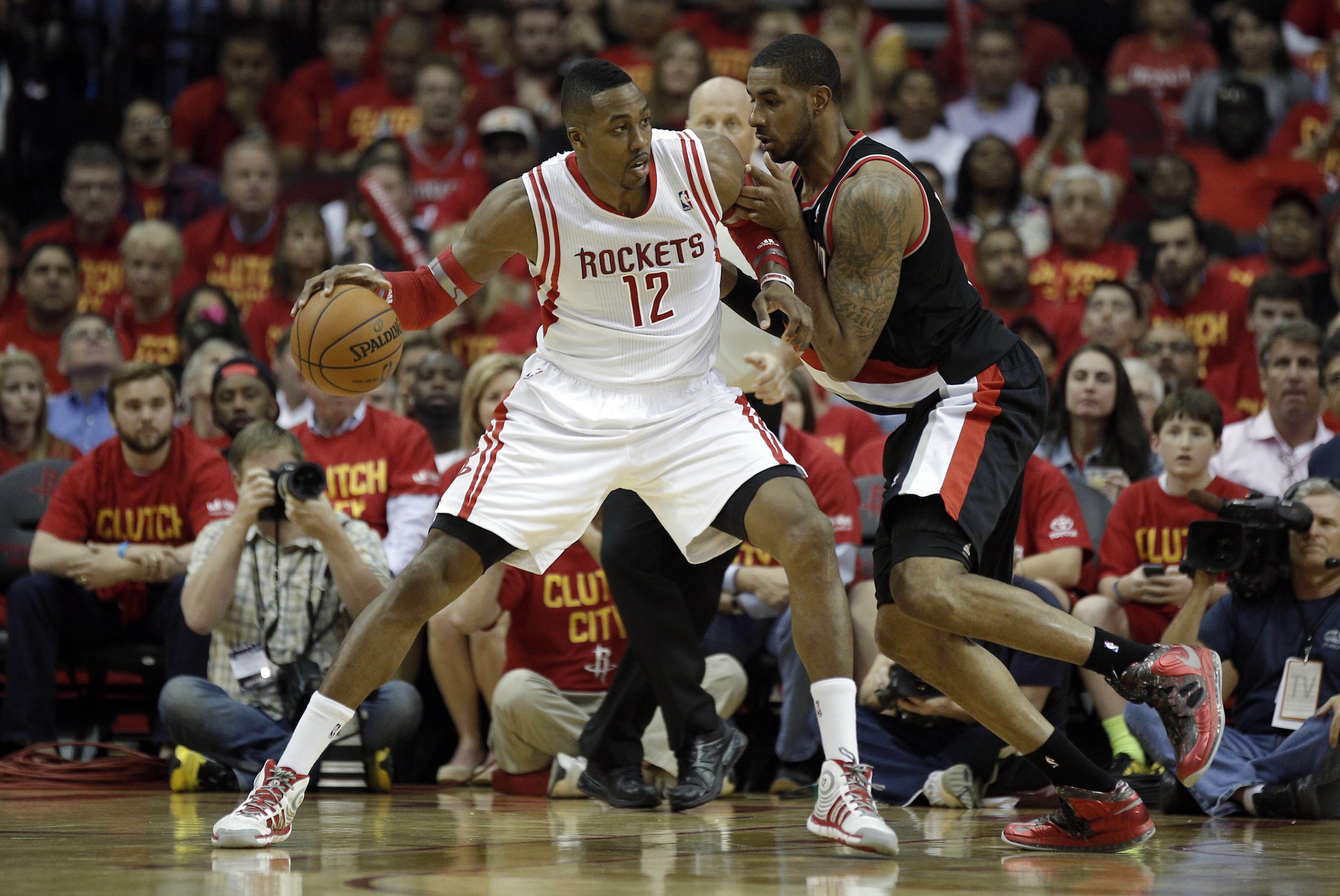 Apr 30, 2014; Houston, TX, USA; Houston Rockets center Dwight Howard (12) is defended by Portland Trail Blazers forward LaMarcus Aldridge (12) during the third quarter in game five of the first round of the 2014 NBA Playoffs at Toyota Center. Mandatory Credit: Andrew Richardson-USA TODAY Sports