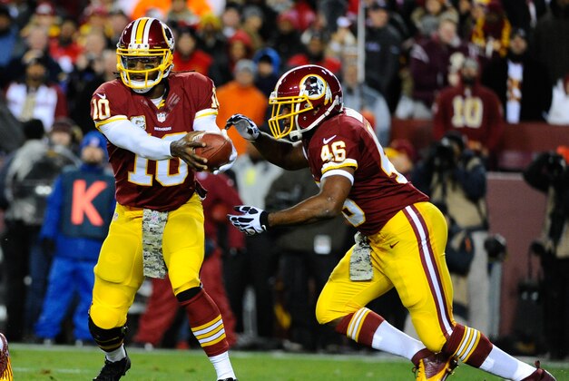 Nov 25, 2013; Landover, MD, USA; Washington Redskins quarterback Robert Griffin III (10) hands the ball off to Washington Redskins running back Alfred Morris (46) during the first half at FedEx Field. Mandatory Credit: Brad Mills-USA TODAY Sports