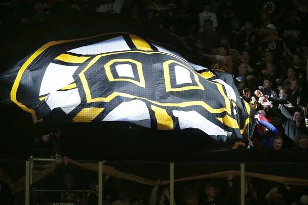 Fans pass a giant Boston Bruins flag around the TD garden before a first round Stanley Cup Playoffs NHL hockey game against the Detroit Red Wings in Boston, Saturday, April 26, 2014. (AP Photo/Michael Dwyer)