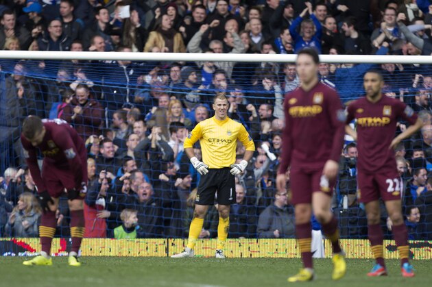 Manchester City's goalkeeper Joe Hart, center, stands in his goal as his team loose 2-0 at Everton in their English Premier League soccer match at Goodison Park Stadium, Liverpool, England, Saturday March 16, 2013. (AP Photo/Jon Super)