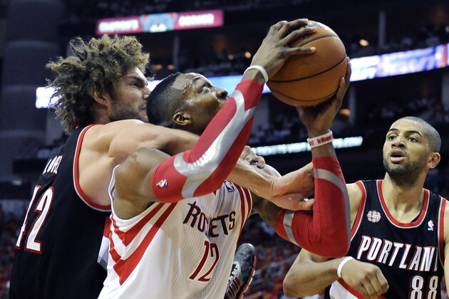Houston Rockets' Dwight Howard (12) is grabbed around the neck by Portland Trail Blazers' Robin Lopez (42) as Nicolas Batum (88) stands near in the second half of Game 5 of an opening-round NBA basketball playoff series Wednesday, April 30, 2014, in Houston. Lopez was charged with a flagrant-1 foul for the move. The Rockets won 108-98 to send the teams back to Portland for Game 6. (AP Photo/Pat Sullivan)