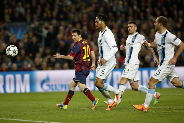 Barcelona's Lionel Messi, left scores during a Champions League, round of 16, second leg, soccer match between FC Barcelona and Manchester City at the Camp Nou Stadium in Barcelona, Spain, Wednesday March 12, 2014. (AP Photo/Emilio Morenatti)