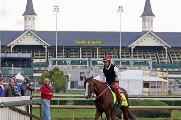 Exercise rider William Delgado takes Kentucky Derby entrant California Chrome for a morning workout at Churchill Downs Thursday, May 1, 2014, in Louisville, Ky. (AP Photo/Charlie Riedel)