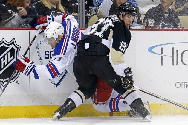 Pittsburgh Penguins' Sidney Crosby (87)checks New York Rangers' John Moore (17) during the second period of an NHL hockey game between the Pittsburgh Penguins and the New York Rangers in Pittsburgh, Friday, Feb. 7, 2014. The Rangers won 4-3 in a shootout. (AP Photo/Gene J. Puskar)
