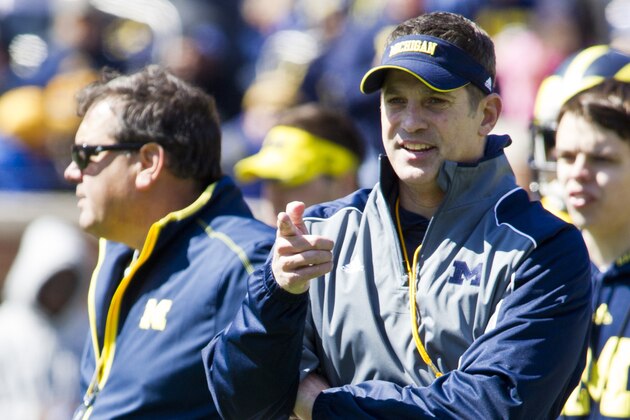 Michigan offensive coordinator Doug Nussmeier, front, stands next to head coach Brady Hoke, left, during the football team's annual spring game, Saturday, April 5, 2014, in Ann Arbor, Mich. (AP Photo/Tony Ding)