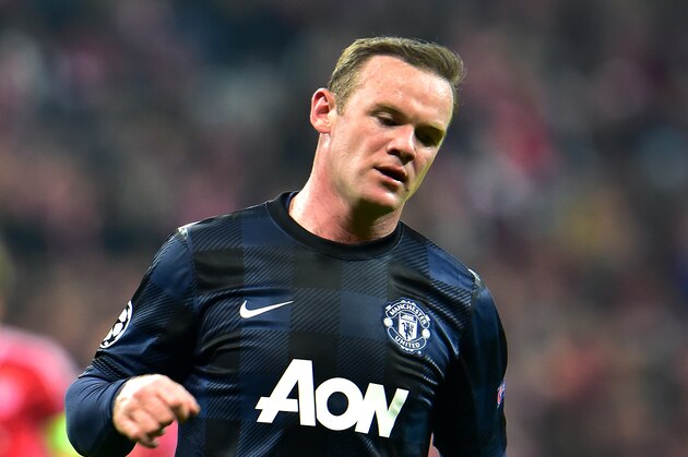 Manchester United's Wayne Rooney looks down during the Champions League quarterfinal second leg soccer match between Bayern Munich and Manchester United in the Allianz Arena in Munich, Germany, Wednesday, April 9, 2014. Munich defeated Manchester by 3:1. (AP Photo/Kerstin Joensson)
