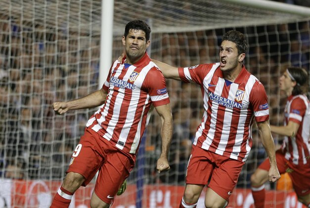 Atletico's Diego Costa, left celebrates with  Koke after he scored a penalty during the Champions League semifinal second leg soccer match between Chelsea and Atletico Madrid at Stamford Bridge Stadium in London Wednesday, April 30, 2014. (AP Photo/Kirsty Wigglesworth)