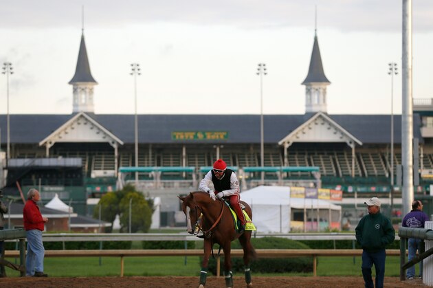 LOUISVILLE, KY - MAY 01:  California Chrome walks off the track with trainer Art Sherman in front of the twin spires during early morning workouts at Churchill Downs on May 1, 2014 in Louisville, Kentucky.  (Photo by Kevin C. Cox/Getty Images)