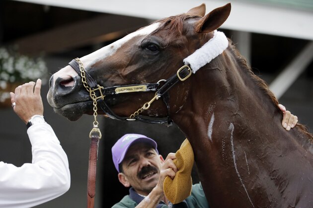Kentucky Derby entrant California Chrome gets a bath after a morning workout at Churchill Downs Thursday, May 1, 2014, in Louisville, Ky. (AP Photo/Charlie Riedel)