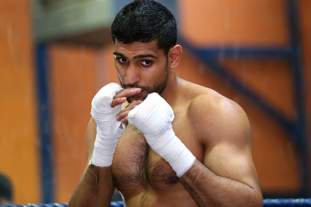 BOLTON, ENGLAND - MARCH 24:  Amir Khan shadow boxes during a media workout at the Gloves Community Centre on March 24, 2014 in Bolton, England.  (Photo by Alex Livesey/Getty Images)
