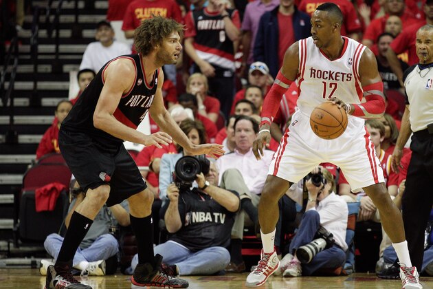 HOUSTON, TX - APRIL 30:  Dwight Howard #12 of the Houston Rockets looks to drive on Robin Lopez #42 of the Portland Trail Blazers in Game 5 of the Western Conference Quarterfinals during the 2014 NBA Playoffs at the Toyota Center on April 30, 2014 in Houston, Texas. NOTE TO USER: User expressly acknowledges and agrees that, by downloading and or using this photograph, User is consenting to the terms and conditions of the Getty Images License Agreement  (Photo by Bob Levey/Getty Images)