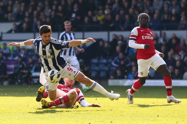 WEST BROMWICH, ENGLAND - APRIL 06:  Per Mertesacker (R) of Arsenal fouls Shane Long of West Brom giving away a penalty and being shown a red card during the Barclays Premier League match between West Bromwich Albion and Arsenal at The Hawthorns on April 6, 2013 in West Bromwich, England.  (Photo by Michael Steele/Getty Images)