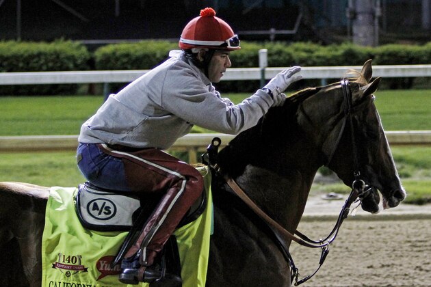 Exercise rider William Delgado takes Kentucky Derby entrant California Chrome for a morning workout at Churchill Downs Friday, May 2, 2014, in Louisville, Ky. (AP Photo/Garry Jones)