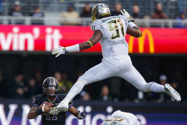 SEATTLE, WA - OCTOBER 12:  Quarterback Keith Price #17 of the Washington Huskies rushes against defensive end Tony Washington #91 of the Oregon Ducks on October 12, 2013 at Husky Stadium in Seattle, Washington. The Ducks defeated the Huskies 45-24.  (Photo by Otto Greule Jr/Getty Images)