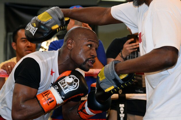 LAS VEGAS, NV - APRIL 22:  Boxer Floyd Mayweather Jr. works out with his trainer and uncle Roger Mayweather at the Mayweather Boxing Club on April 22, 2014 in Las Vegas, Nevada. Mayweather will face Marcos Maidana in a 12-round world championship unification bout in Las Vegas on May 3.  (Photo by Ethan Miller/Getty Images)