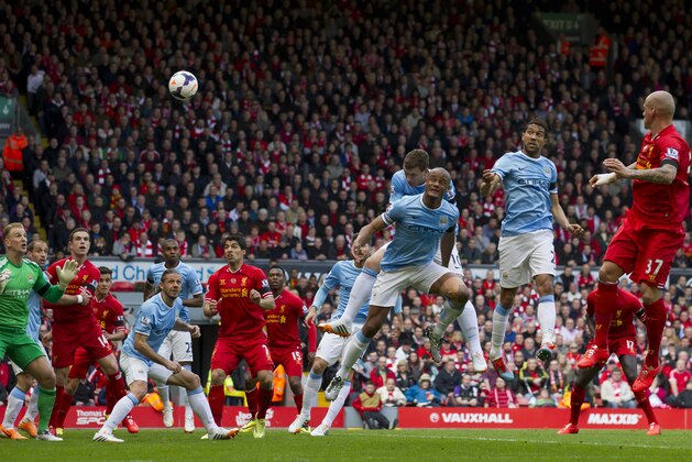Liverpool's Martin Skrtel, right, scores against Manchester City during their English Premier League soccer match at Anfield Stadium, Liverpool, England, Sunday April 13, 2014. (AP Photo/Jon Super)