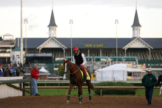 LOUISVILLE, KY - MAY 01:  California Chrome walks off the track with trainer Art Sherman in front of the twin spires during early morning workouts at Churchill Downs on May 1, 2014 in Louisville, Kentucky.  (Photo by Kevin C. Cox/Getty Images)