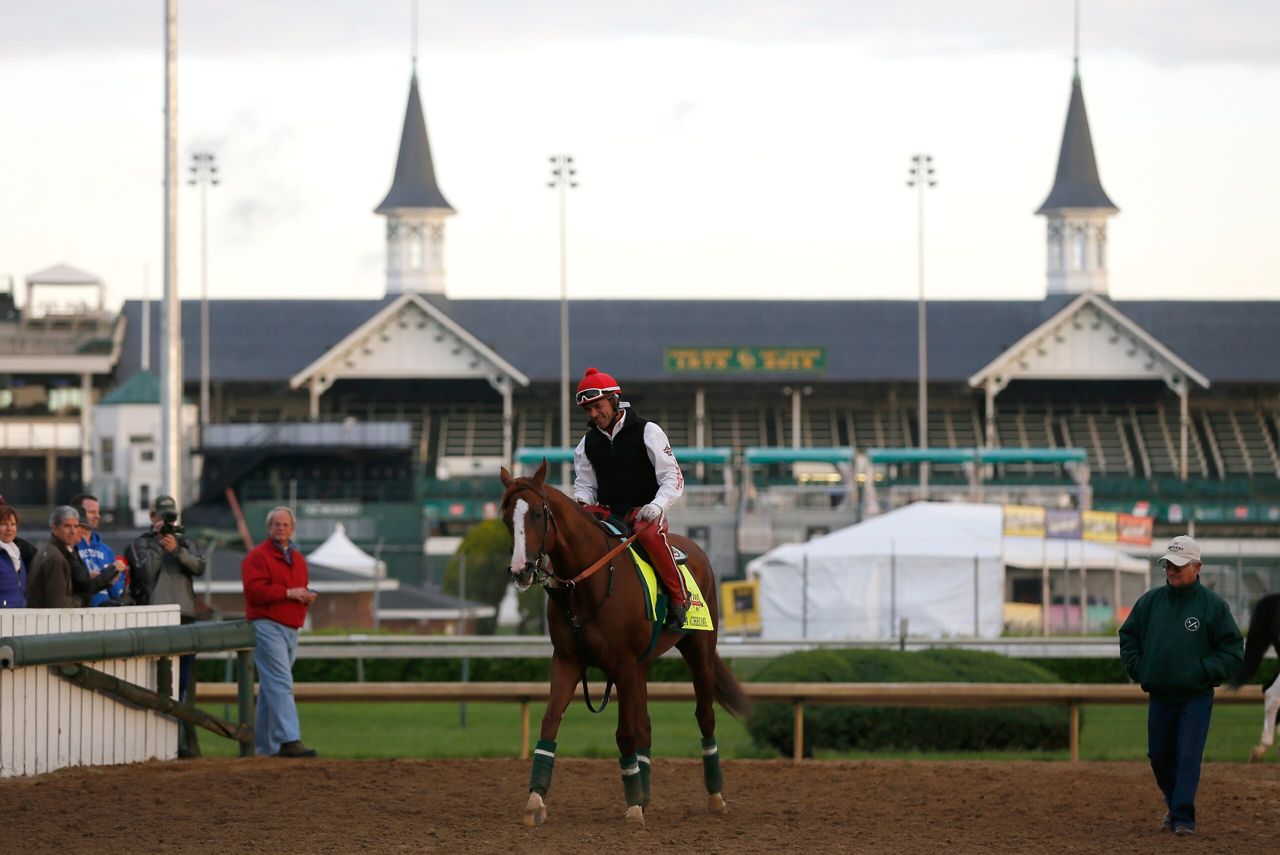 LOUISVILLE, KY - MAY 01:  California Chrome walks off the track with trainer Art Sherman in front of the twin spires during early morning workouts at Churchill Downs on May 1, 2014 in Louisville, Kentucky.  (Photo by Kevin C. Cox/Getty Images)