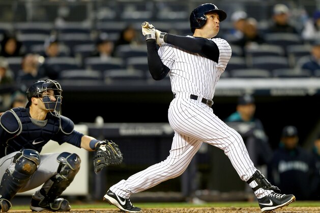 NEW YORK, NY - APRIL 29:  Mark Teixeira #25 of the New York Yankees hits a solo home run in the second inning as Mike Zunino #3 of the Seattle Mariners defends on April 29, 2014 at Yankee Stadium in the Bronx borough of New York City.  (Photo by Elsa/Getty Images)