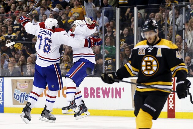 Montreal Canadiens defenseman Francis Bouillon jumps with defenseman P.K. Subban (76) to celebrate his goal as Boston Bruins center David Krejci, right, skates away during the third period in Game 1 of an NHL hockey second-round playoff series in Boston, Thursday, May 1, 2014. (AP Photo/Elise Amendola)