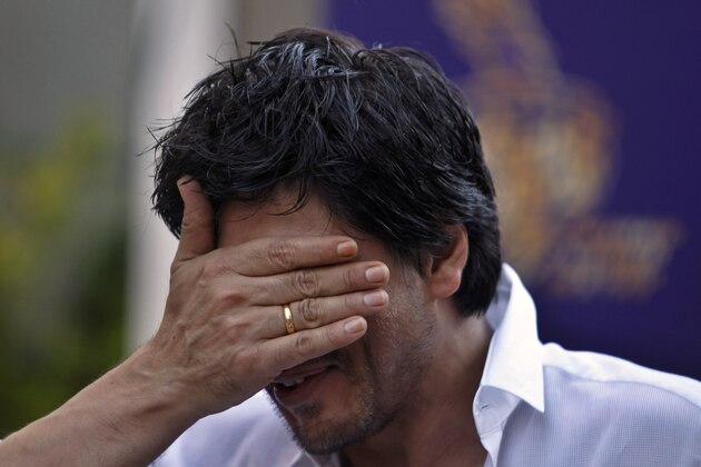 Kolkata Knight Riders team co-owner and Bollywood star Shah Rukh Khan gestures during a press conference at his residence in Mumbai, India, Wednesday, May 30, 2012. Kolkata Knight Riders won the Indian Premier League (IPL) cricket title on Sunday, defeating two-time defending champion Chennai Super Kings by five wickets in a high-scoring final. (AP Photo/Rafiq Maqbool)