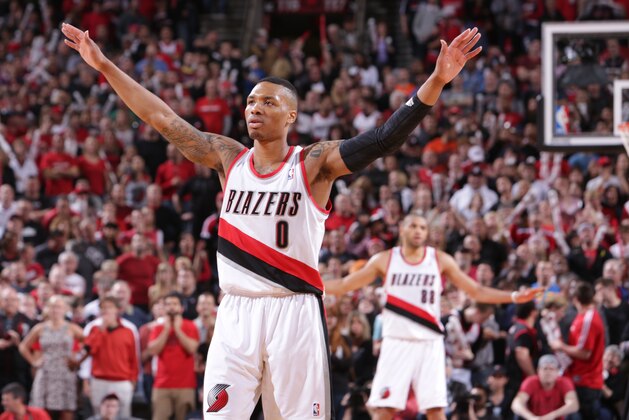 PORTLAND, OR - APRIL 25:  Damian Lillard #0 of the Portland Trail Blazers celebrates against the Houston Rockets in Game Three of the Western Conference Quarterfinals during the 2014 NBA Playoffs on April 25, 2014 at the Moda Center in Portland, Oregon. NOTE TO USER: User expressly acknowledges and agrees that, by downloading and or using this photograph, User is consenting to the terms and conditions of the Getty Images License Agreement. Mandatory Copyright Notice: Copyright 2014 NBAE (Photo by Sam Forencich/NBAE via Getty Images)