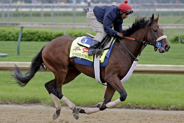 Exercise rider Kelvin Pahal takes Kentucky Derby hopeful Wicked Strong for a morning workout at Churchill Downs Wednesday, April 30, 2014, in Louisville, Ky. (AP Photo/Morry Gash)