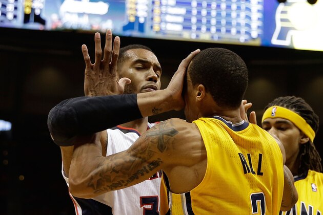 ATLANTA, GA - MAY 01:  Forward Mike Scott #32 of the Atlanta Hawks pushes forward George Hill #3 of the Indiana Pacers in the face in Game 6 of the Eastern Conference Quarterfinals during the 2014 NBA Playoffs at Philips Arena on May 1, 2014 in Atlanta, Georgia.  NOTE TO USER:  User expressly acknowledges and agrees that, by downloading and/or using this photograph, User is consenting to the terms and conditions of the Getty Images License Agreement.  (Photo by Mike Zarrilli/Getty Images)