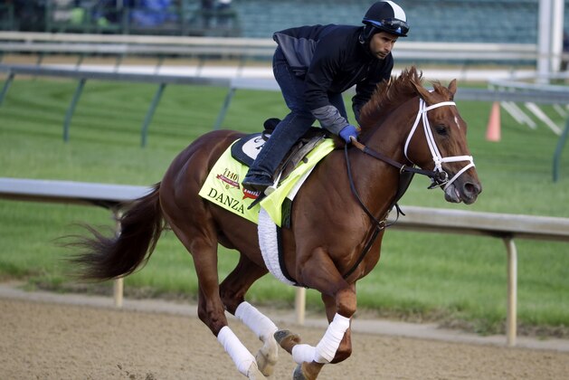 Exercise rider Ezequiel Perez takes Kentucky Derby entrant Danza for a morning workout at Churchill Downs Thursday, May 1, 2014, in Louisville, Ky. (AP Photo/Morry Gash)