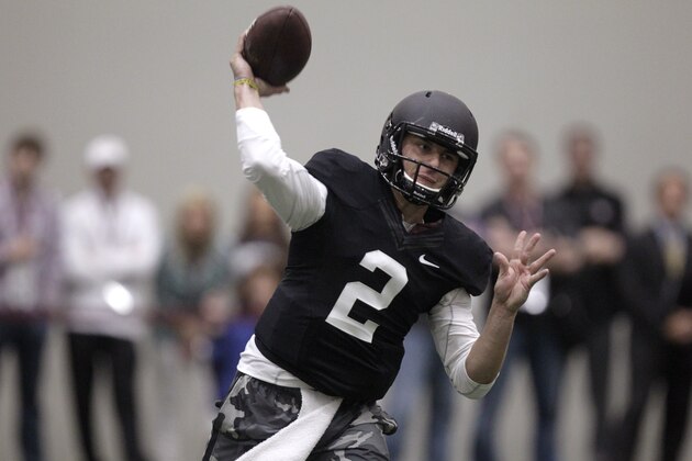 Texas A&M quarterback Johnny Manziel passes the ball during a drill at pro day for NFL football representatives in College Station, Texas, Thursday, March 27, 2014. (AP Photo/Patric Schneider)