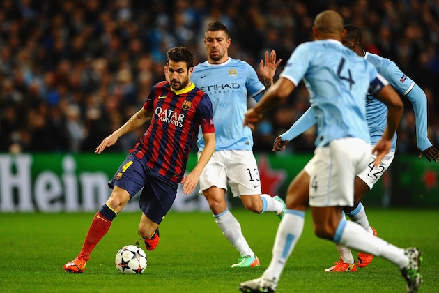 MANCHESTER, ENGLAND - FEBRUARY 18:  Cesc Fabregas of Barcelona competes with Aleksandar Kolarov of Manchester City during the UEFA Champions League Round of 16 first leg match between Manchester City and Barcelona at the Etihad Stadium on February 18, 2014 in Manchester, England.  (Photo by Laurence Griffiths/Getty Images)